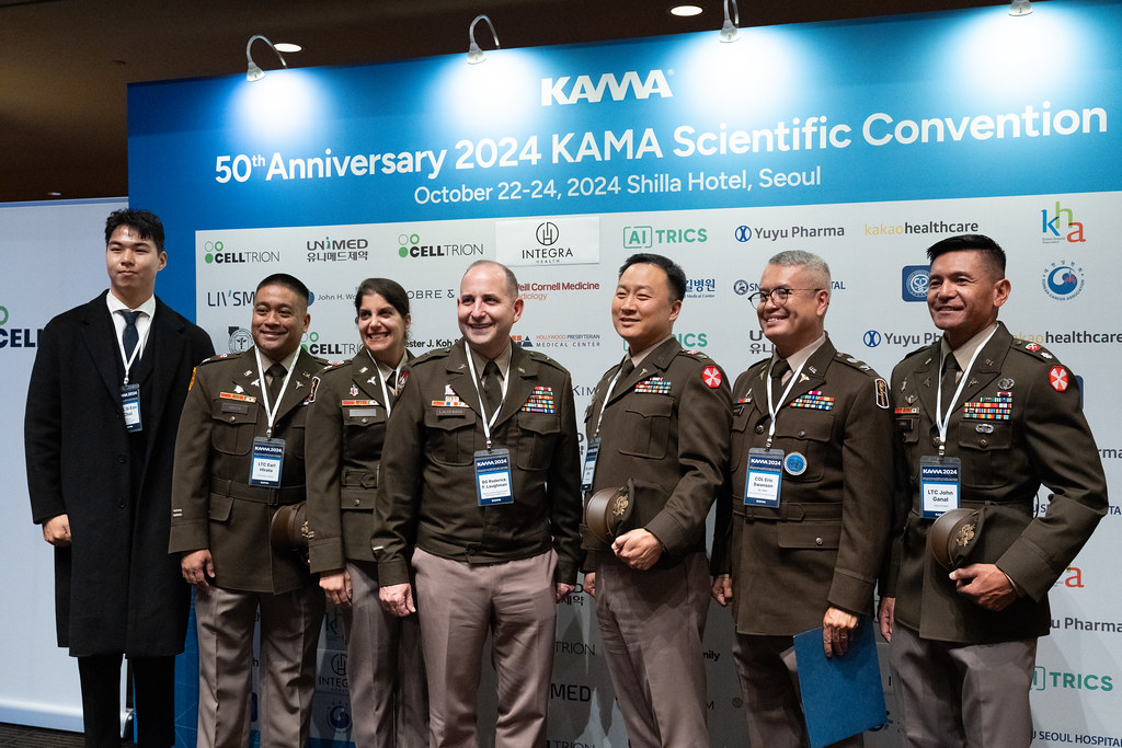 Members at 50th anniversary sponsors backdrop